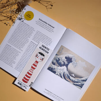 marque page kokeshi yajiro posé sur livre